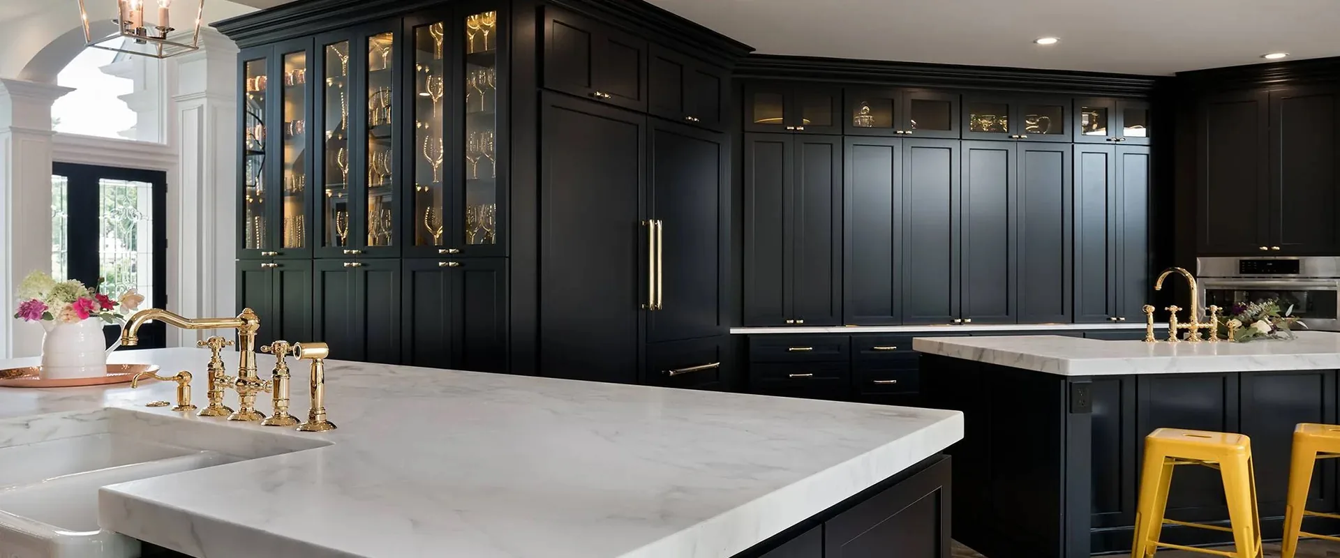 Custom black kitchen with brass hardware by Paradise Home Design